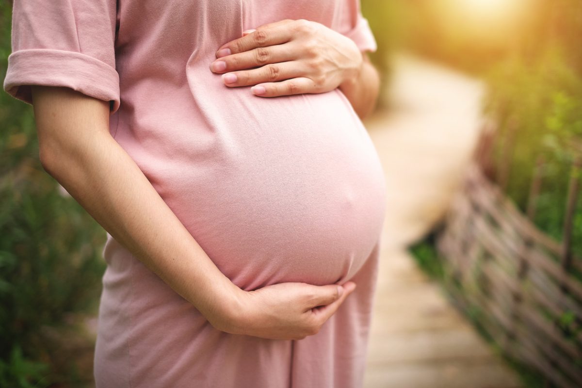 Lady touching her tummy, considering birnest for pregnancy